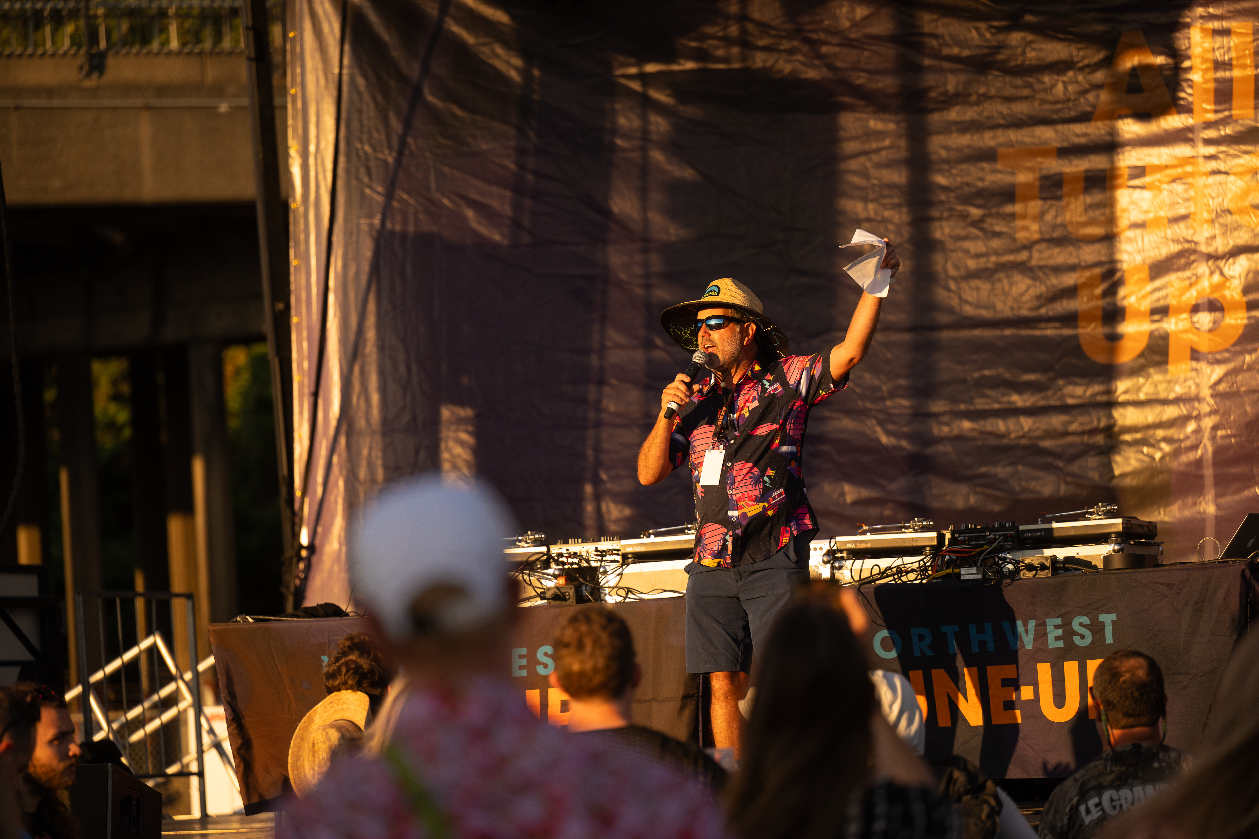 A NW Tune-Up staff member addresses the audience from the main stage