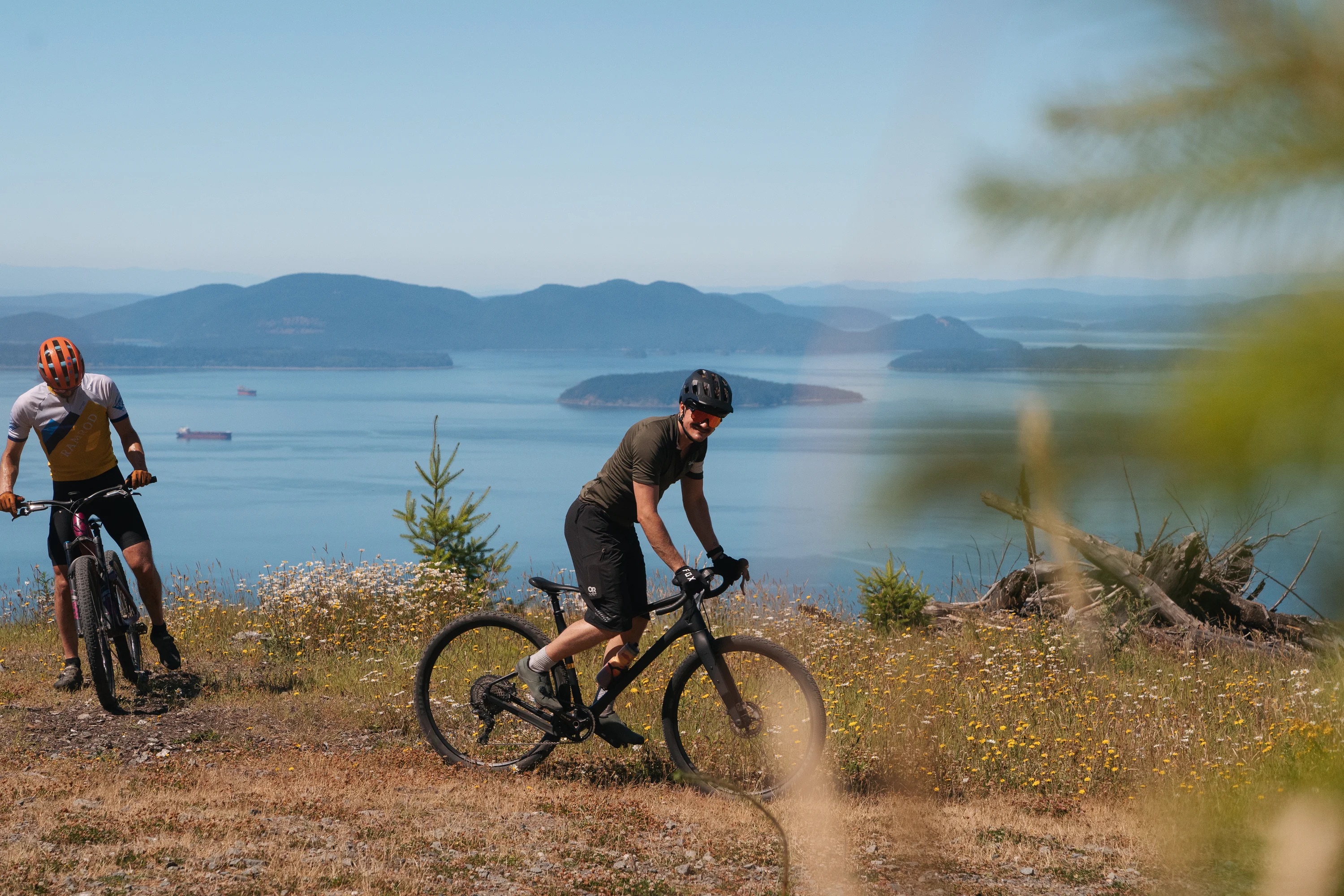 A rider pedals atop a ridge looking out to the Puget Sound and San Juan Islands