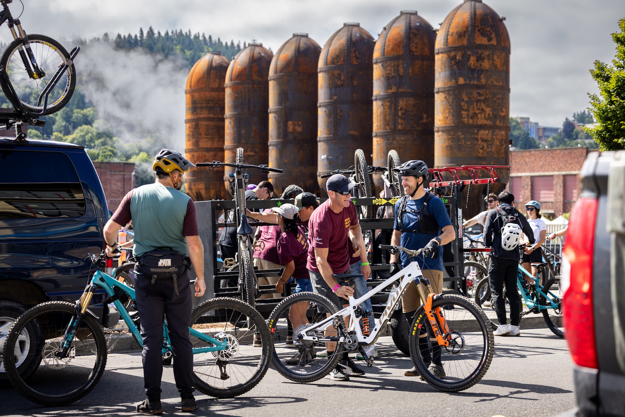 Cyclists load their bikes on the festival bike shuttles