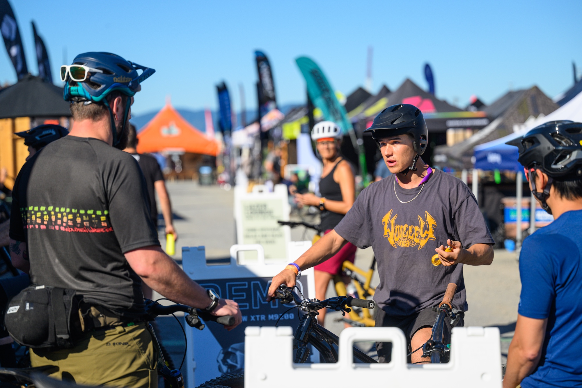 Festivalgoers talk to cycling brand reps.